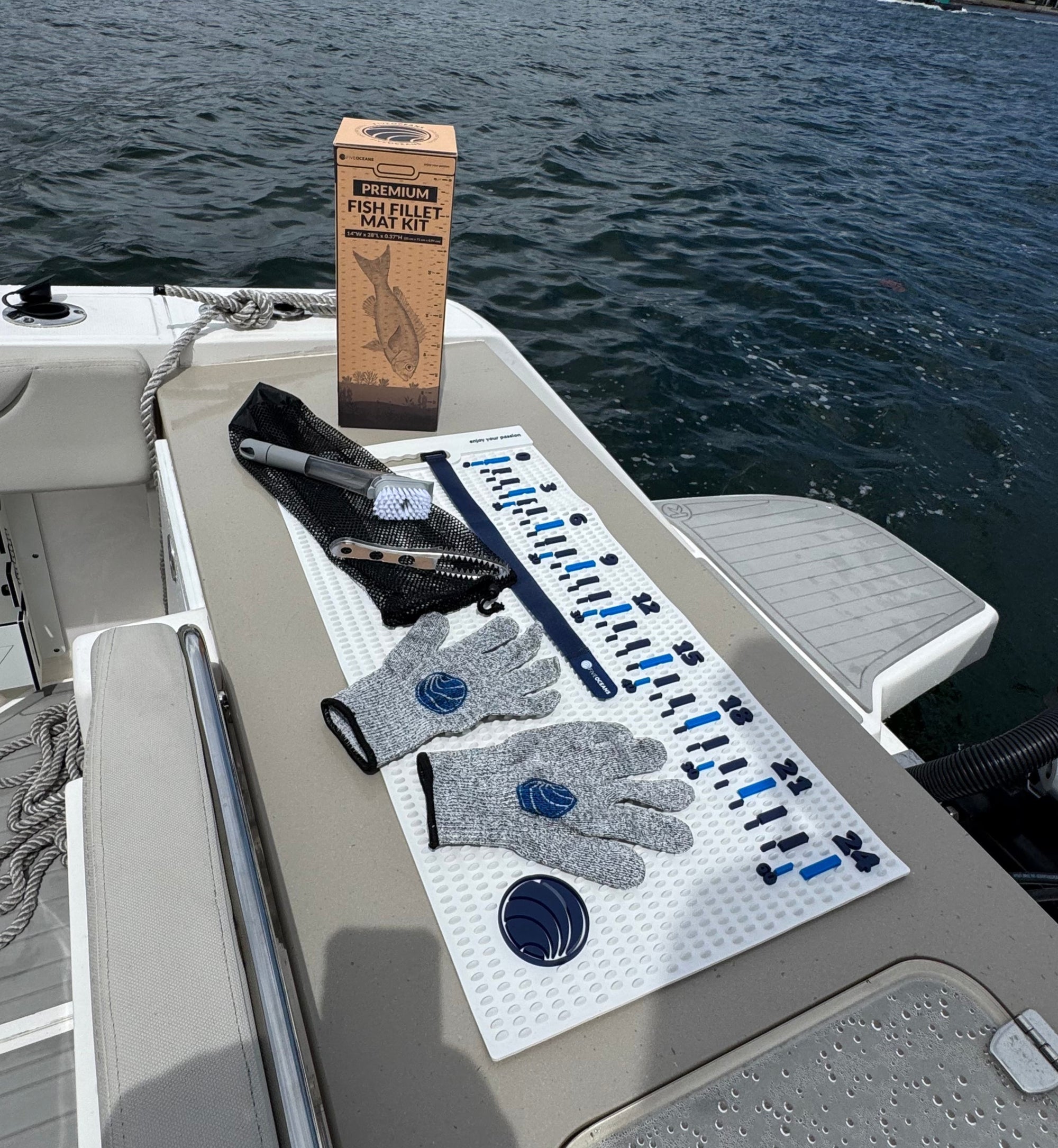 Complete Fish Fillet Mat Kit with 28x14 heavy-duty non-slip mat, fillet knife, cut-resistant gloves, scaling tool, and cleaning brush
